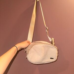 Elegant Cream Crossbody Bag with Fuzzy Front Feature and Key Lock Feature!